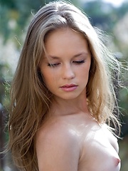 Caesaria is a young innocent girl who is outside getting a little natural light on her tender skin. - Pics