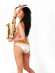 Janice in panties playing the saxophone topless - Pics