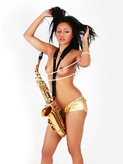 Janice in panties playing the saxophone topless - Pics
