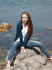 Milena looks delicately sweet and   sexy, wearing a silver cardigan and   her angelic, youthful appeal as she   plays and have fun at the rocky beach.