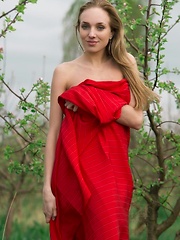 Tayra A playfully posing with a bright red fabric wrapped around her delicate, naked body - Pics