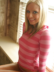 Petite teen babe Skye teases with her perky tits as she lifts her pink striped shirt - Pics