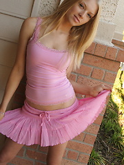 Cute blonde teen Skye teases with her perky tits outside in her pink top and short skirt with a black g-string underneath - Pics