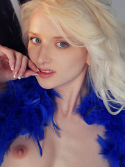 White thigh-high stockings and bright blue slingback peep toe pumps accentuates Nika N's sexy long legs as she poses seductively for the camera with a blue feather boa wrapped around her body. - Pics
